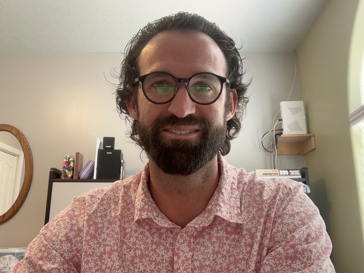 Tyler Patten, PMHNP-BC, seated at his home office desk during a telehealth video visit — the view patients see on screen during an appointment